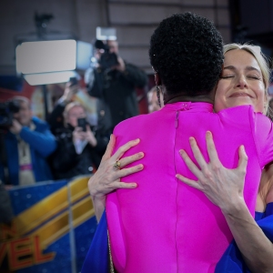 Lashana Lynch and Brie Larson hug at the UK Gala Screening of Marvel Studios